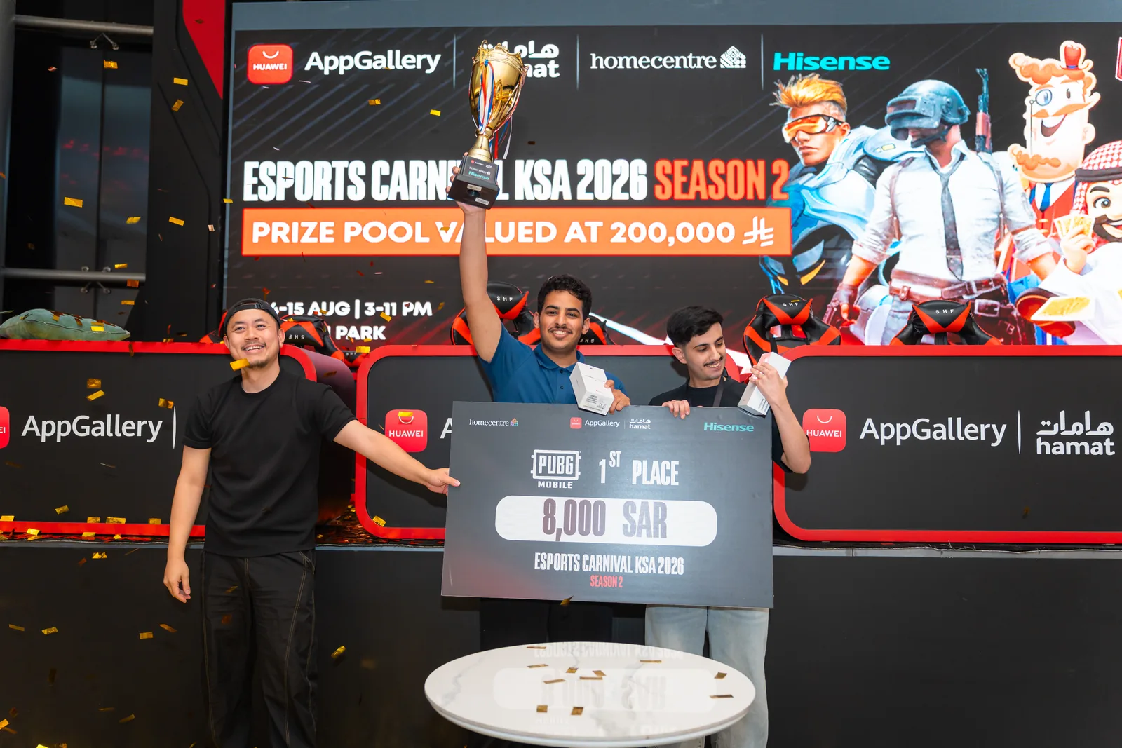 PUBG MOBILE winner holding the first-place trophy and prize board