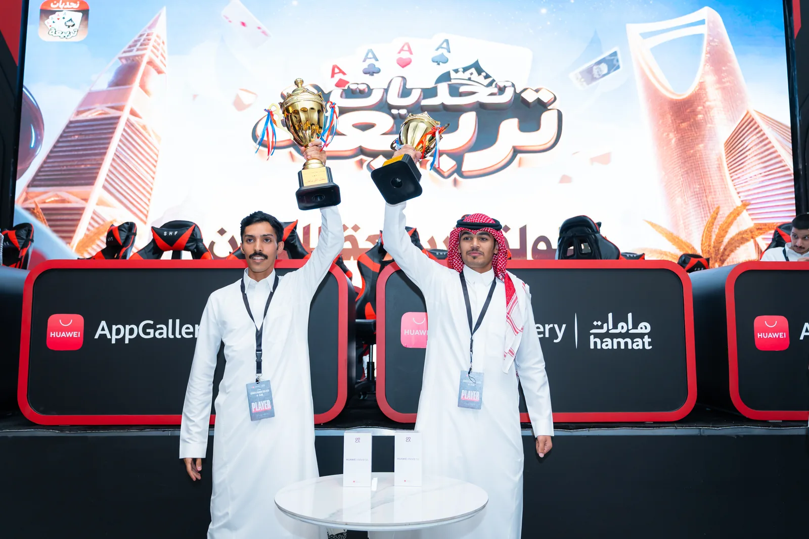 Two Tarbi3ah challenge winners raising their trophies on stage